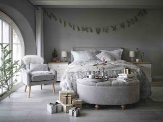 grey bedroom with bed and armchair