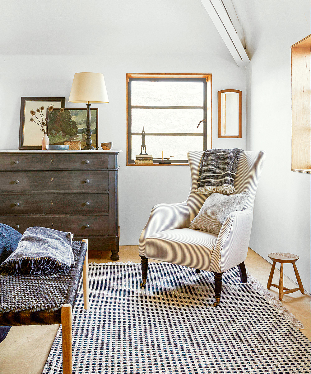 A comfy armchair in the corner of a bedroom