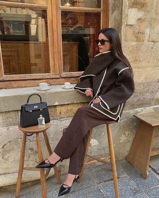 @leasy_inparis wearing burgundy cigarette trousers with a scarf coat