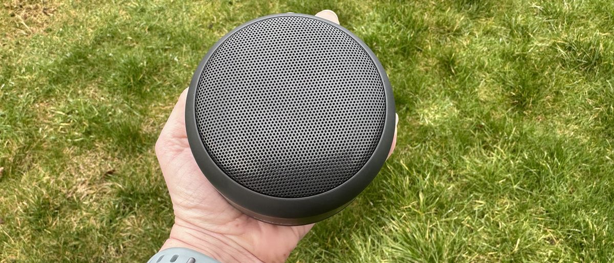 Someone holding the Nokia Portable Wireless Speaker 2 against grass.