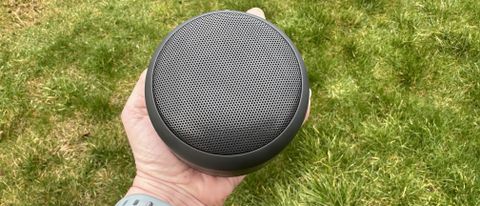 Someone holding the Nokia Portable Wireless Speaker 2 against grass.
