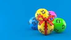 Lotto balls with red ribbon isolated on blue background