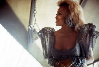 Tina Turner wearing silver attire in a scene from the film 'Mad Max Beyond Thunderdome', 1985.