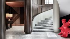 marble staircase with red sculpture next to it