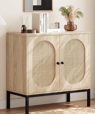 A wooden storage cabinet with decor on top