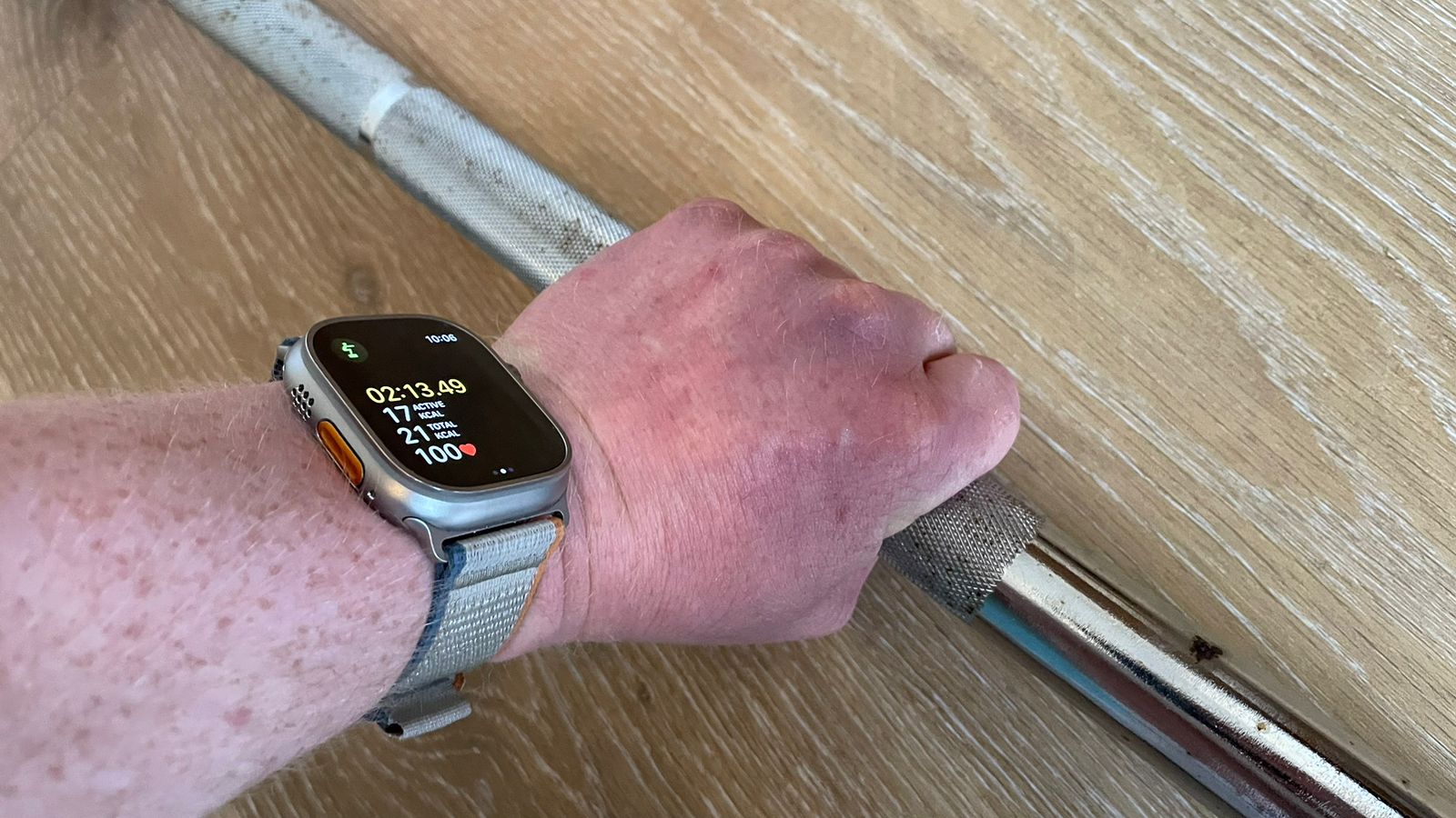 Fitness writer Harry Bullmore gripping a barbell while wearing an Apple Watch Ultra 2