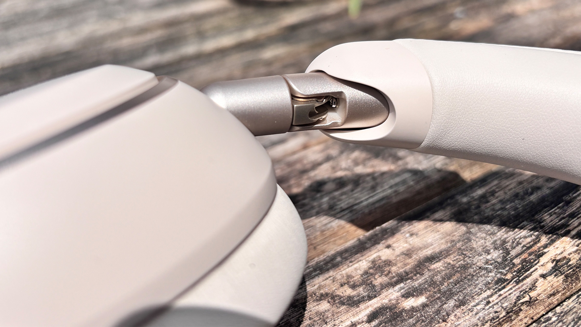 Soundcore Space 2 wireless headphones on wooden surface, close up on earcup, hinge and handle