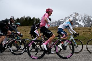 Tadej Pogačar takes a feed on stage 17 of the Giro d'Italia