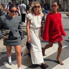 women in stylish clothes crossing the street