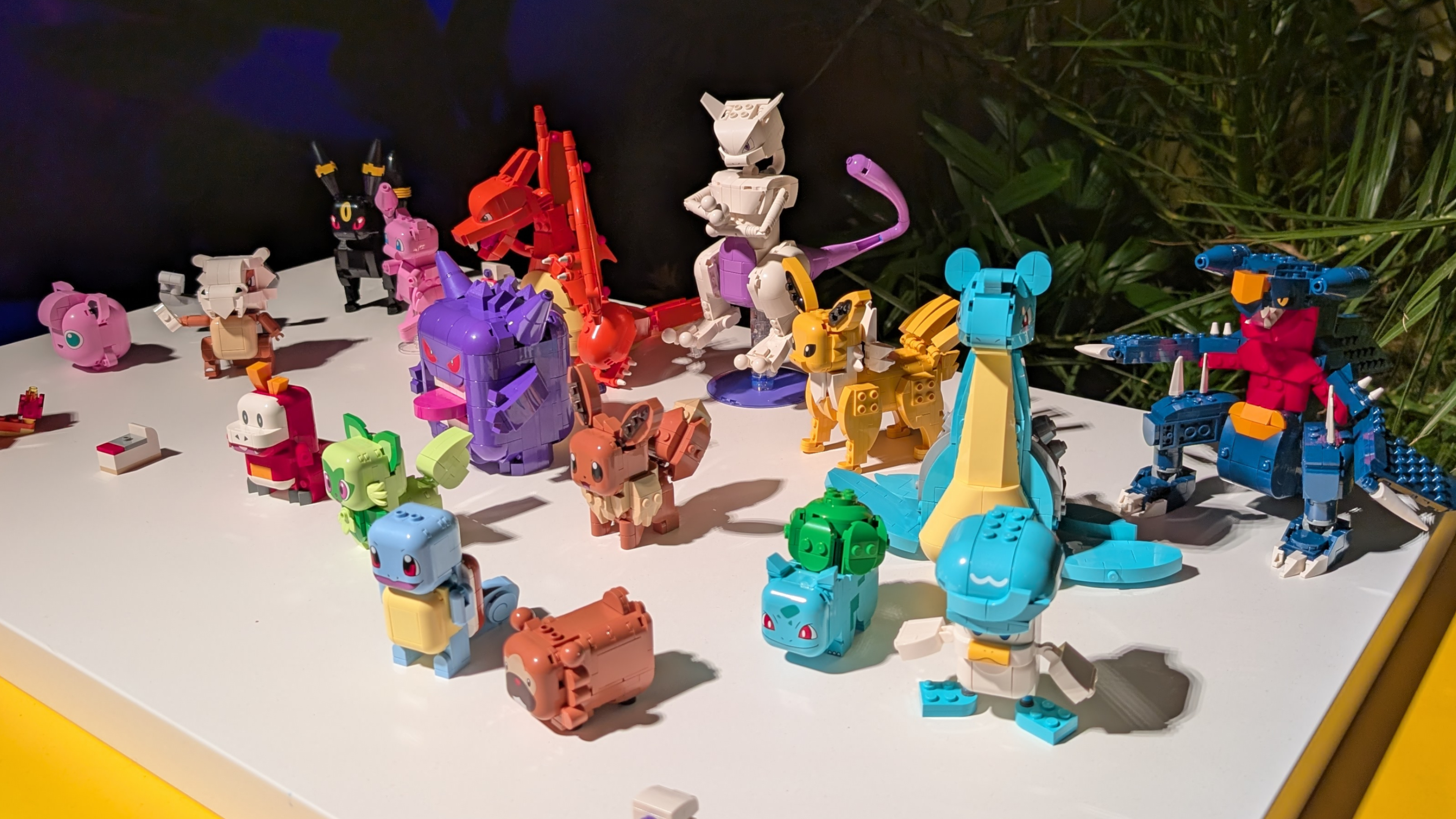 An array of Lego Smart Play Pokemon sets laid out on a white table