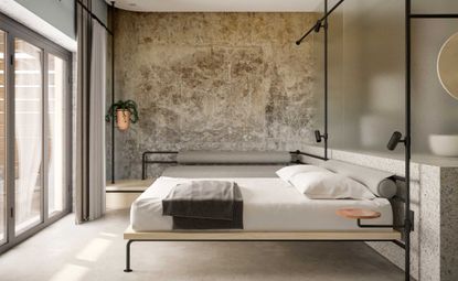 Bedroom, bed on steel pipe framework, glass panels seperate bathroom