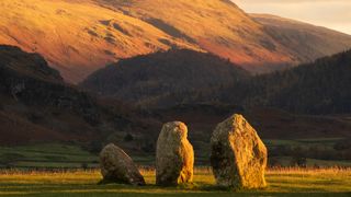 Castlerigg Stone Circle bathed in golden light in the Lake District, Cumbria, United Kingdom.