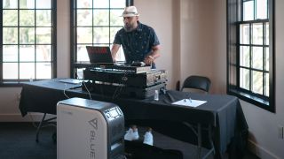 A man DJs at an occasion, powered by the BLUETTI EP500
