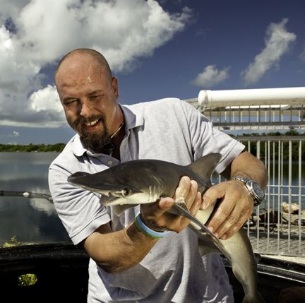 SharkDefense researcher Patrick Rice with a bonnethead shark at the Aquaranch facility in Long Key, Florida. Bonnethead sharks were used to perform the initial tests on the shark repellent hook.