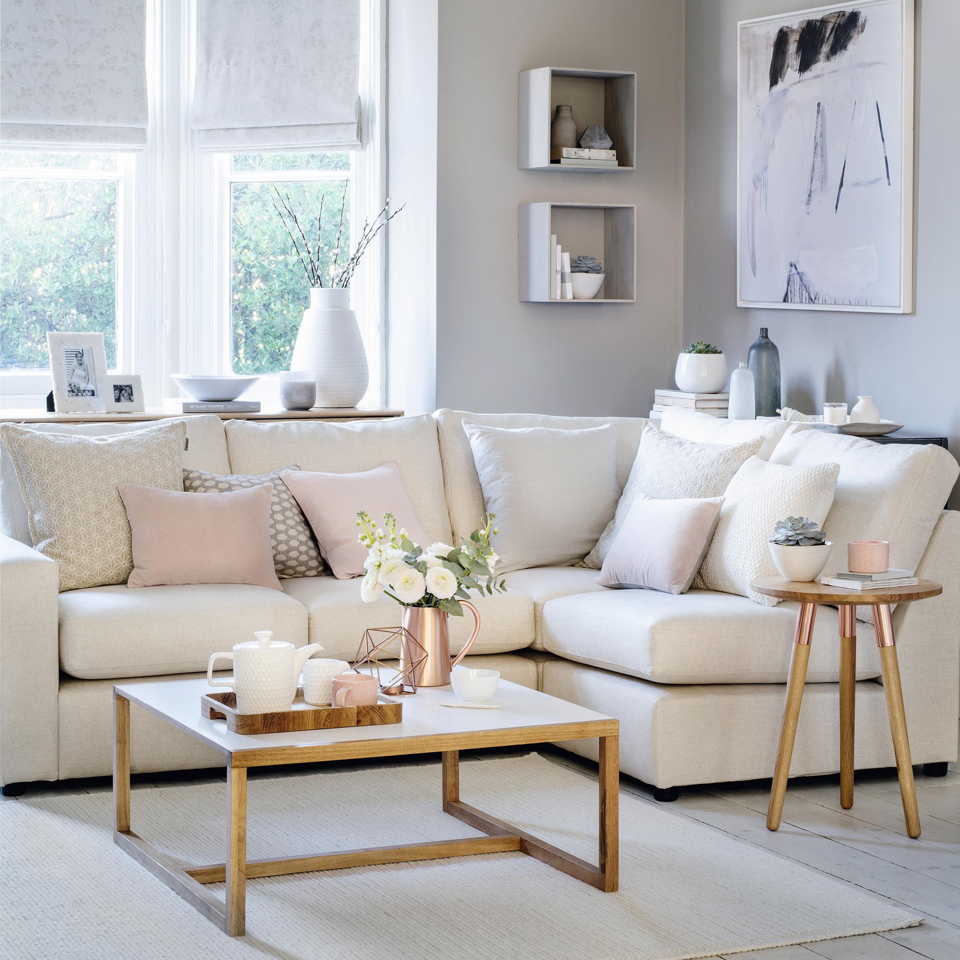 white living room with white sofa and blinds