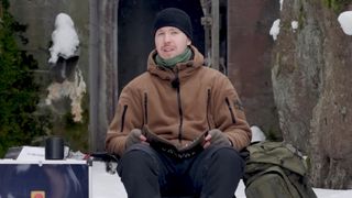 Road to Vostok developer on a chair in the snow