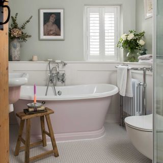 freestanding pink tub and wall panelling in cottage bathroom