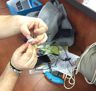 A student from James I O’Neill High School fixing his earbuds with a 3Doodler Pen