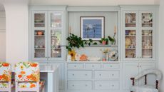 pale blue kitchen cabinets with bright bar stools