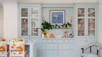 pale blue kitchen cabinets with bright bar stools
