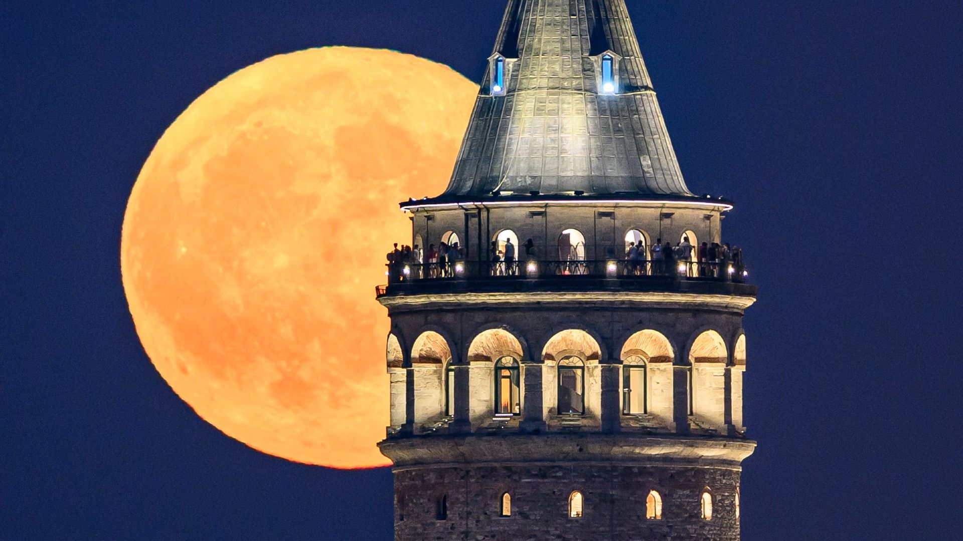
                                The Sturgeon Moon rises over the Galata Tower in Istanbul
                            