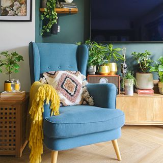 living room with blue armchair and cushion