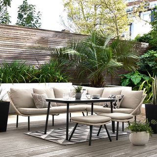 garden with dining furniture and wooden flooring