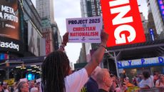 A protestor holds a sign at an Anti-Project 2025 rally in Times Square in July