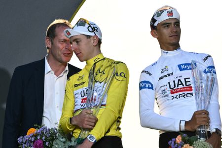 Director of the Tour de France Christian Prudhomme speak to UAE Team Emirates - XRG's Slovenian rider Tadej Pogacar speaks as he celebrates with UAE Team Emirates - XRG's Mexican rider Isaac Del Toro (R) on the podium with the overall leader's yellow jersey after the 21st stage of the 113th edition of the Tour de France cycling race, 88,7 km starting and finishing in Paris, on July 26, 2026. (Photo by Jeff PACHOUD / AFP)
