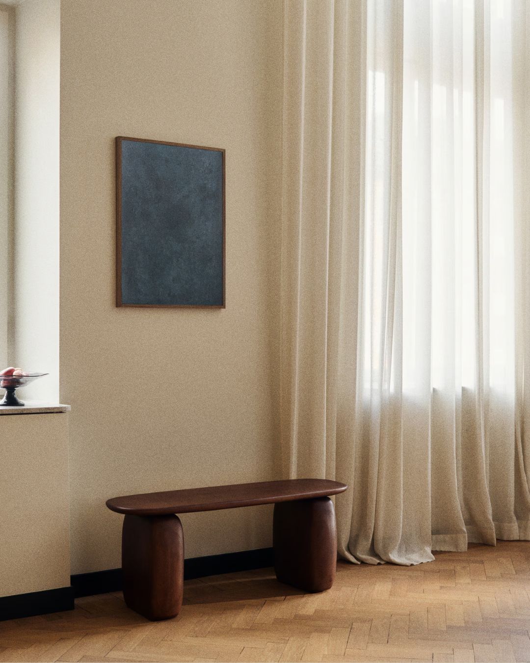 Pinewood Bench styled in a naturally lit, beige-painted living room with herringbone-style tiled floors and a blue abstract canvas on the wall.