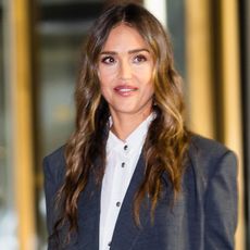 Jessica Alba wears a gray blazer over a white shirt