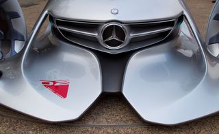 The front of the Mercedes Silver Arrow. We see a grille with a Mercedes logo and front bumpers that lay low.