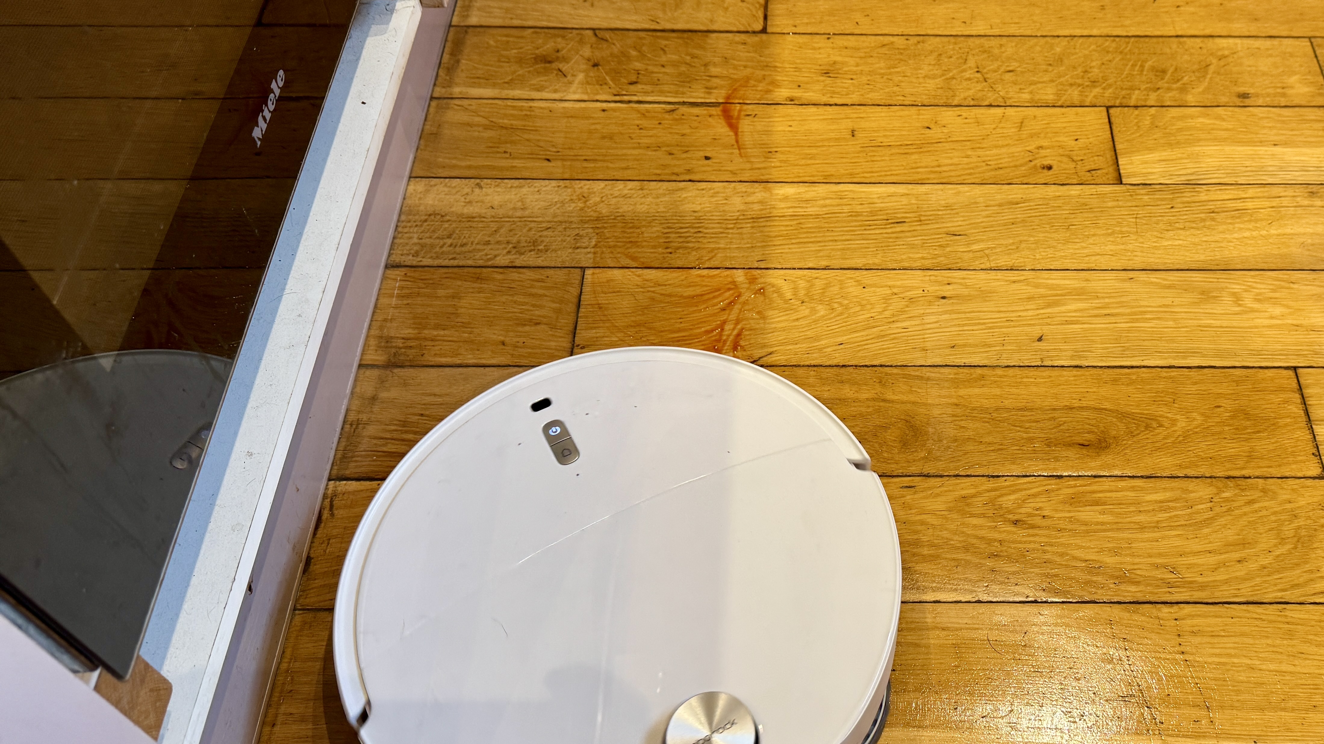 Roborock Qrevo Curv 2 Pro cleaning a spillage from a hard floor