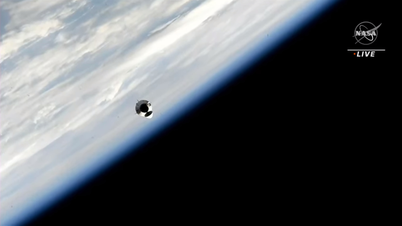 A space capsule with the blue edge of Earth behind bordered by black space