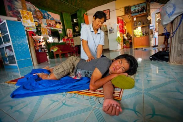 Arashiro Yukiya is massaged by a local masseuse