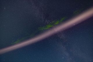 A portrait of the infamous STEVE arc of hot flowing gas associated with an active aurora, here showing his distinctive pink colour and the fleeting appearance of the green picket fence fingers that often show up hanging down from the main arc