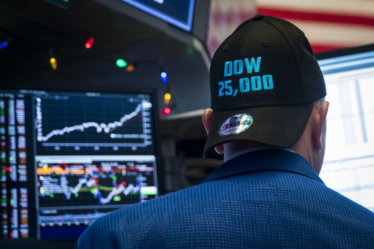 A trader wears a hat to celebrate the Dow&amp;#039;s new record