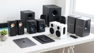 Lots of speakers set on a desktop. 