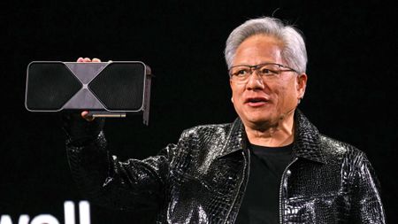 Jensen Huang holding an Nvidia RTX GPU.