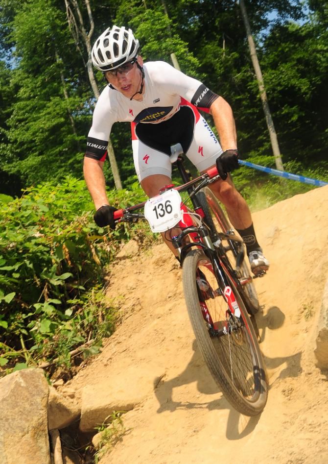 Sean Bennett (Specialized) racing in third place as he enters a steep chute