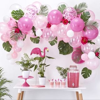 white wall with balloons and plant in pots