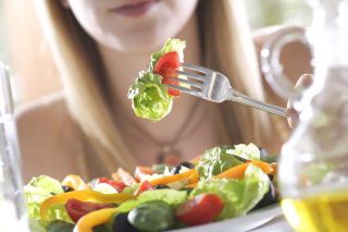 Avoid relationship weight gain: woman eating salad