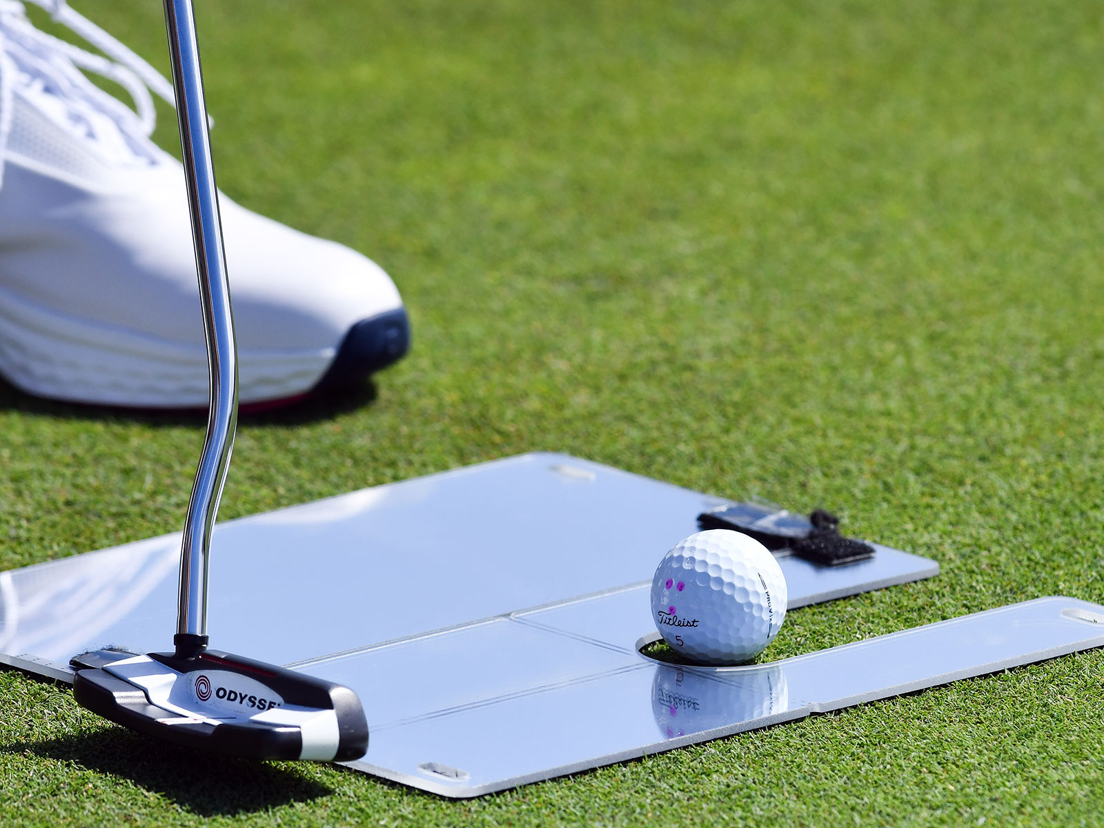 A close up of a golf putting mirror