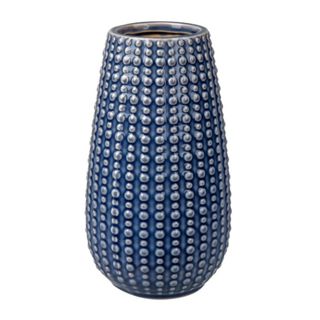 A curved blue vase with a dotted pattern