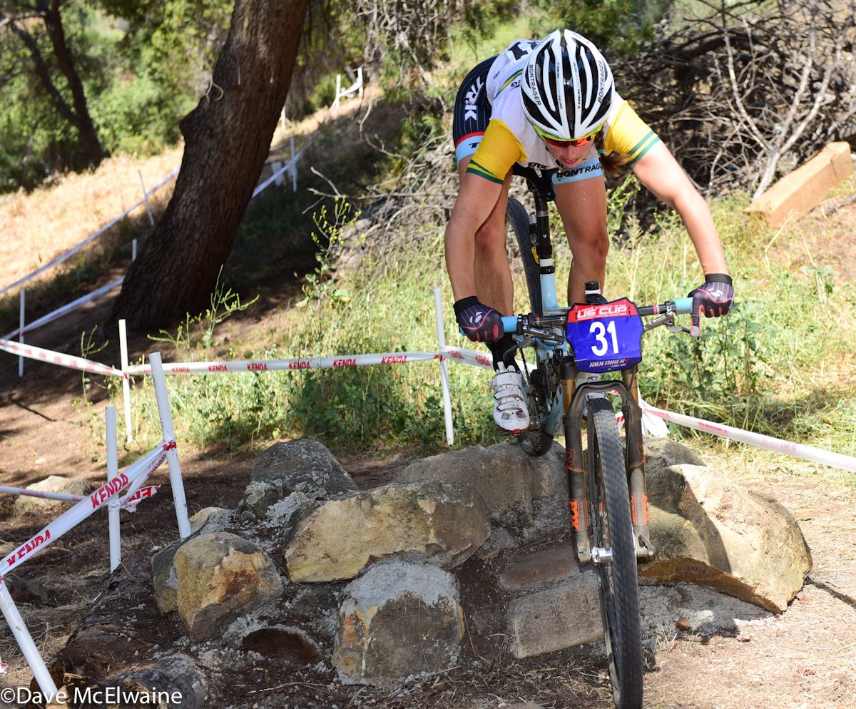Rebecca Henderson (Trek Factory Racing) riding over a rock obstacle.