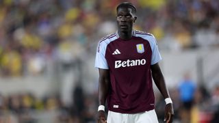 Amadou Onana on the pitch in a Aston Villa claret and blue home shirt.