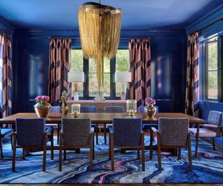 dining room with blue walls and pink patterned curtains