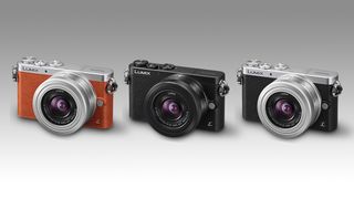 Three color variants (orange, silver and black) of the Panasonic Lumix GM1 camera