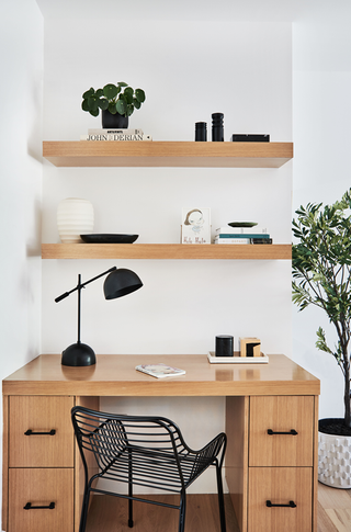 An office desk with open shelves for storage