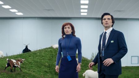 Helly and Mark standing on an artificial hill surrounded by goats in Severance season 2 episode 3